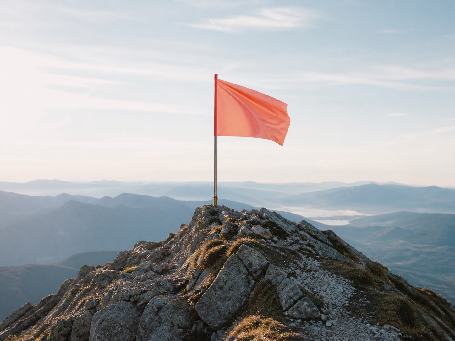 Flag planted on a mountain summit